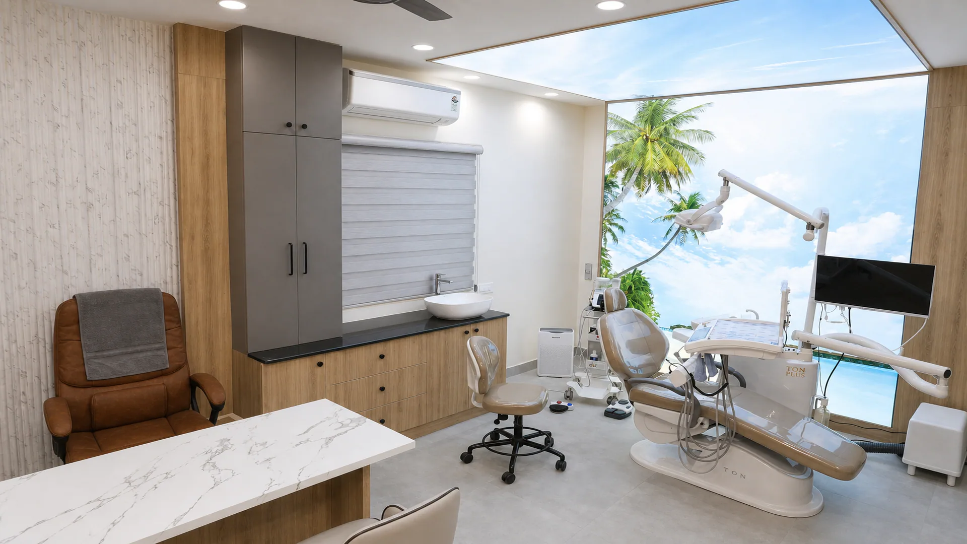 Wide dental treatment room with clinical equipment, built-in cabinetry and a tropical landscape wall image.