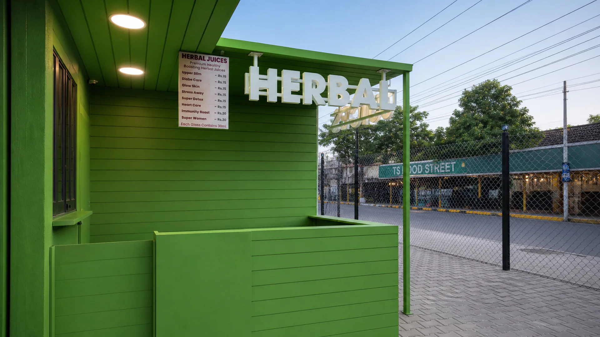 Green exterior counter beneath an illuminated herbal sign.