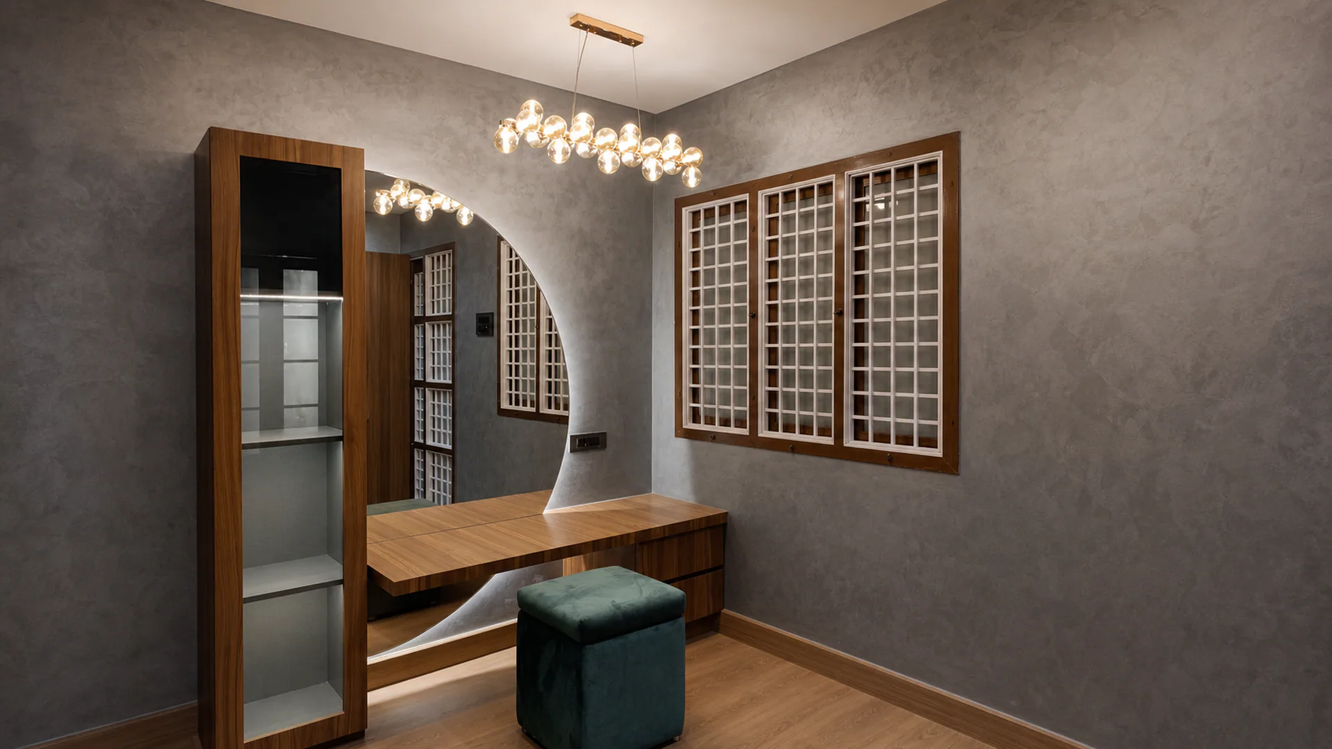 Dressing area with a wall mirror, suspended drawer and upholstered stool.
