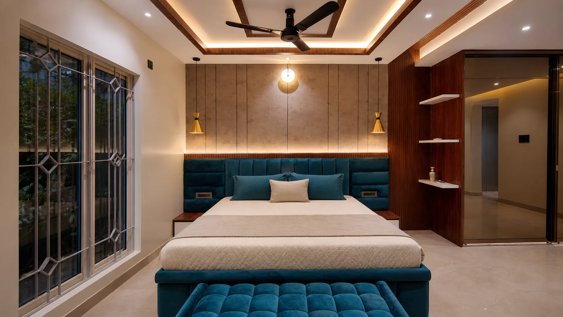 Front view of a bed with teal upholstered headboard, bench and pendant lights.