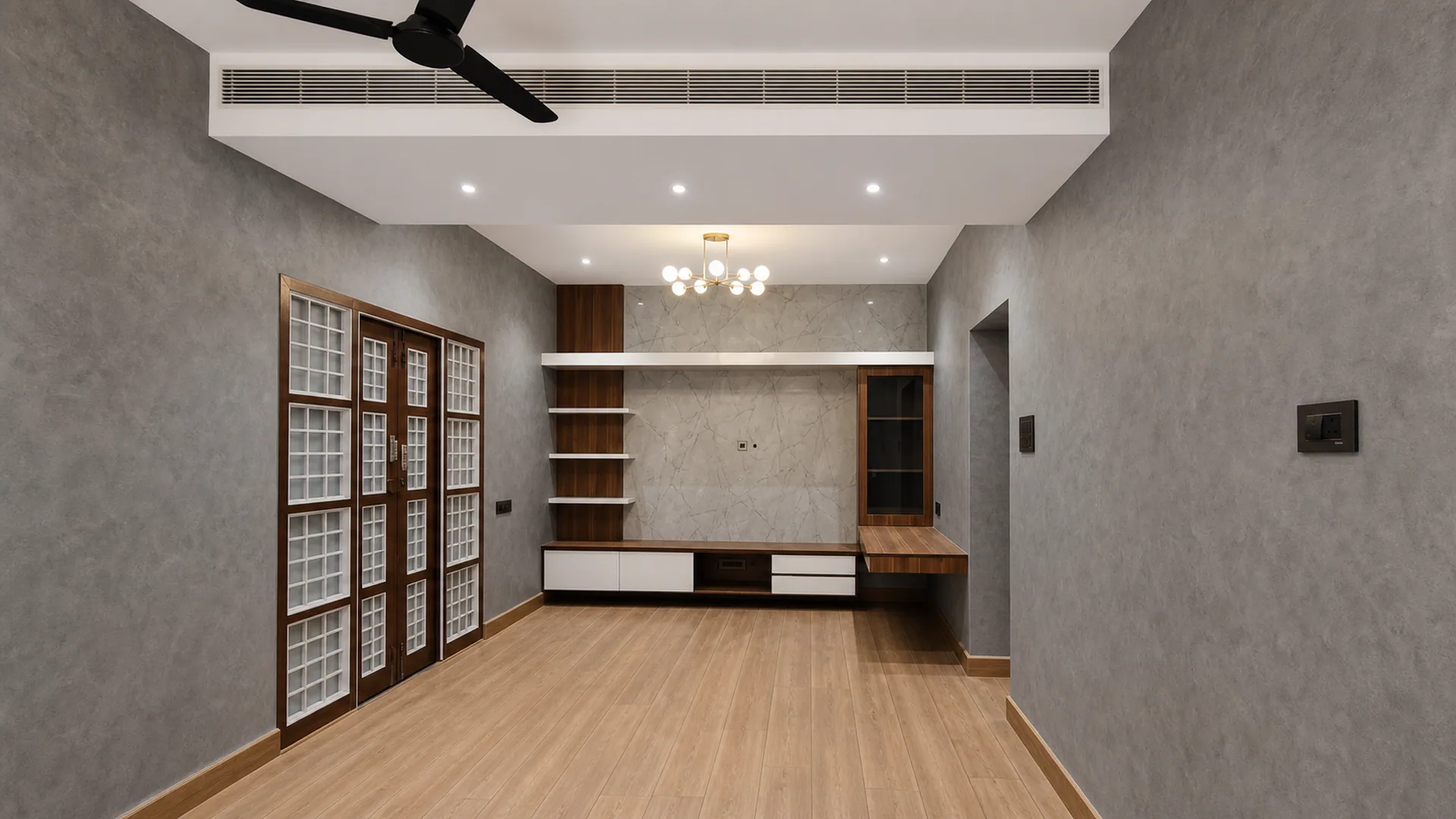 Unfurnished room with a long media unit, windows and a ceiling light fixture.