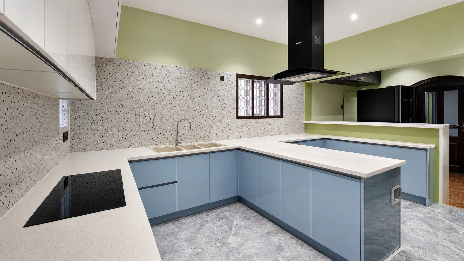 Kitchen with blue lower cabinets, white worktops and a central island.