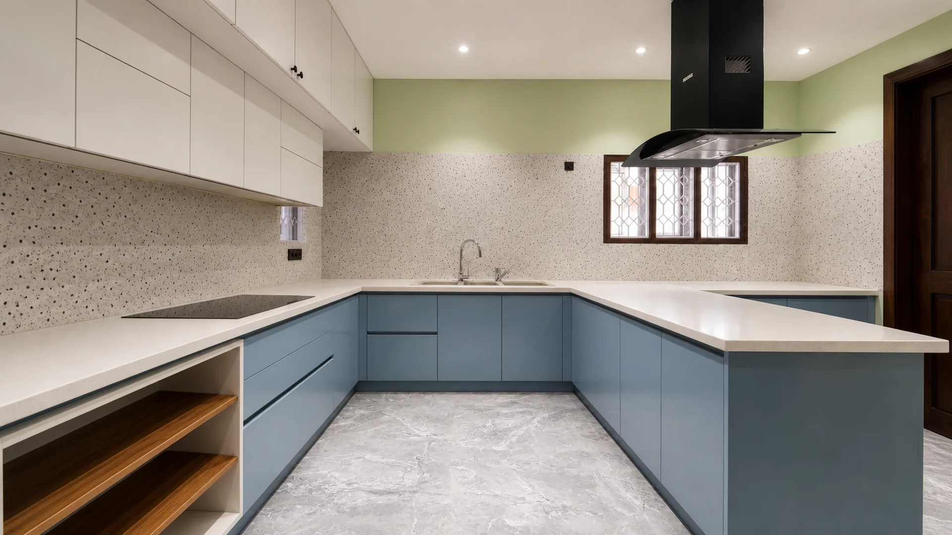 Kitchen worktop with blue lower cabinets, white upper cabinets and dark hood.