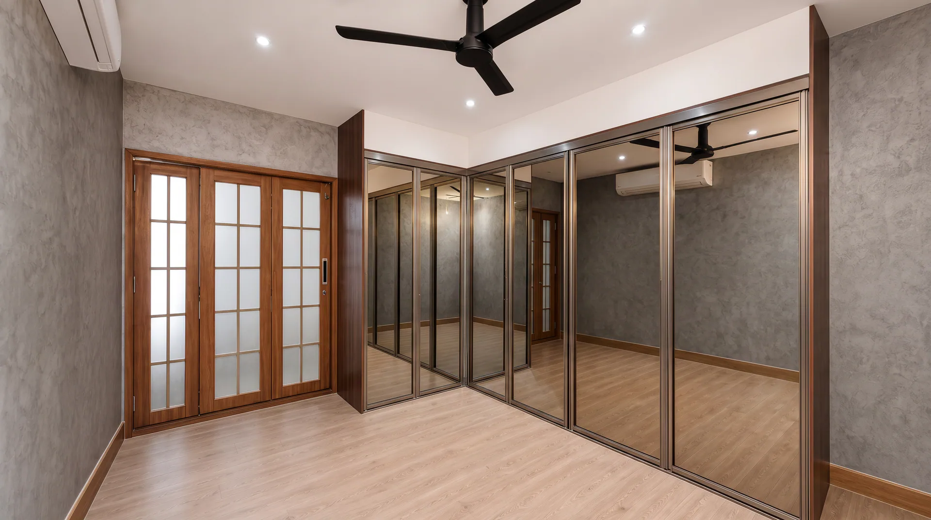Interior room with full-height mirrored wardrobe doors, wood-framed glazed doors and a ceiling fan.