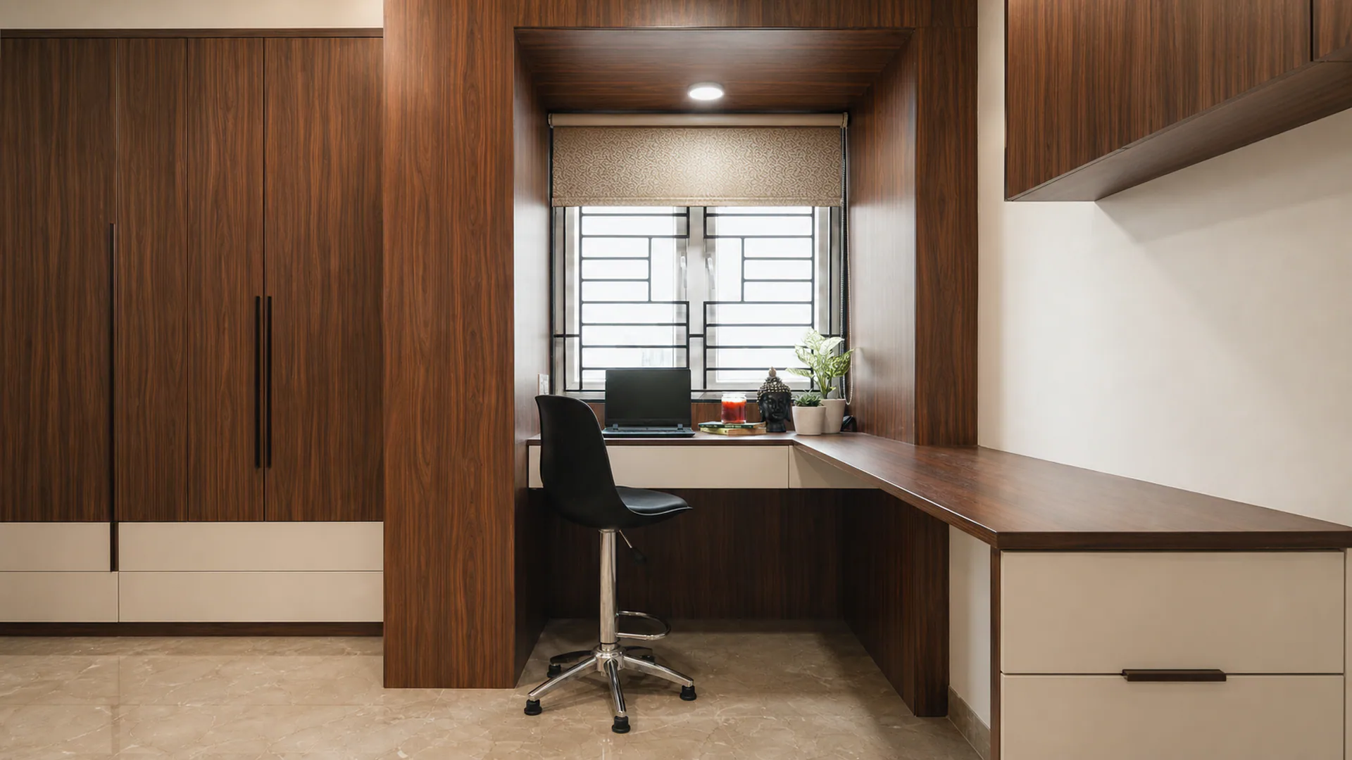 Built-in study desk framed by full-height wood-finished storage.