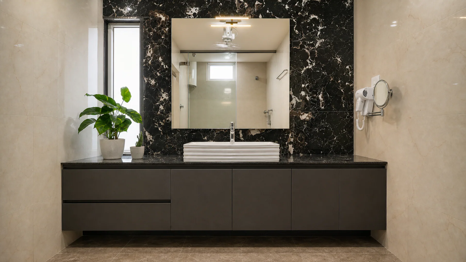 Wall-mounted dark vanity beneath a mirror with a contrasting dark surround.